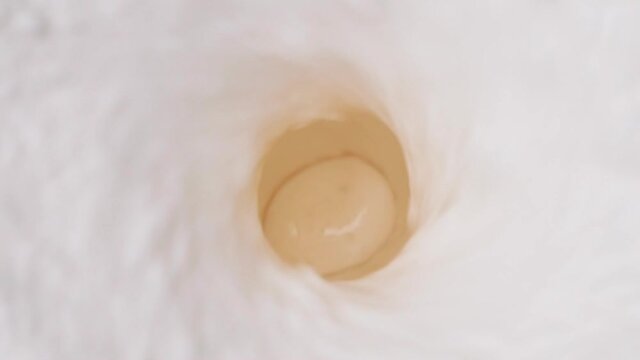 Milk blended in blender with splashes, top view. Healthy eating concept.