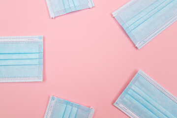 Medical Equipment. Five Disposable Medical Face Masks Lying on Pink Background