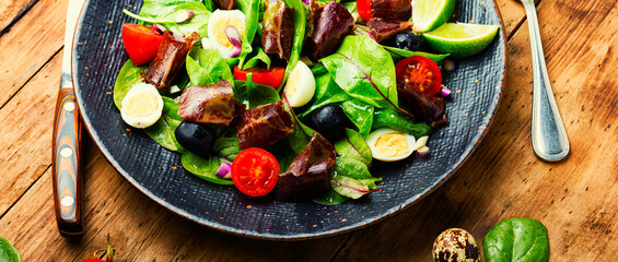 Delicious salad with vegetables, herbs and ham