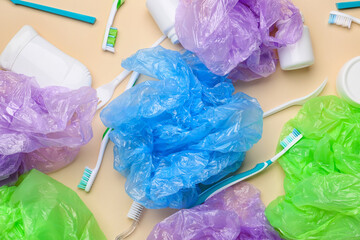 Crumpled bags and plastic garbage on color background