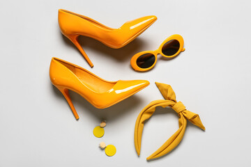 Set of female accessories with stylish sunglasses on grey background