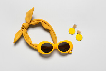 Set of female accessories with stylish sunglasses on grey background