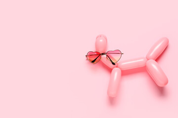 Creative composition with balloon dog and sunglasses on color background
