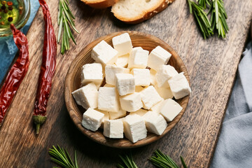 Bowl with delicious pieces of feta cheese on board
