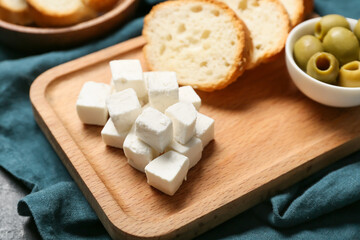 Tray with delicious pieces of feta cheese on napkin