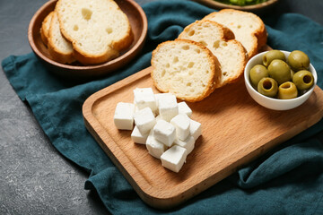 Composition with delicious pieces of feta cheese on dark background