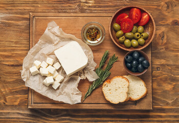 Composition with delicious pieces of feta cheese on wooden background