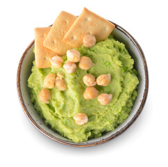 Bowl with tasty green pea hummus and crackers on white background