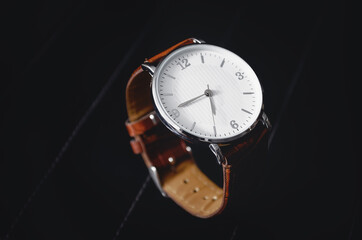 Men's watch on a black background, a place for an inscription.