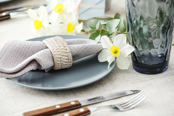 Beautiful table setting with narcissus flowers