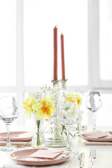 Beautiful table setting with narcissus flowers