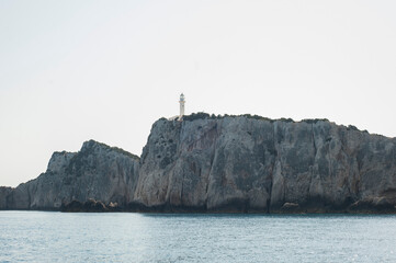 Fototapeta na wymiar Boathouse, lighthouse on sea