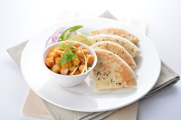 Indian vegetable bean curry with baked naan pizza bread in white background vegan dim sum Halal menu
