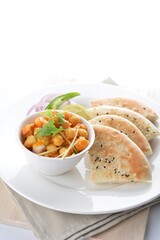 Indian vegetable bean curry with baked naan pizza bread in white background vegan dim sum Halal menu