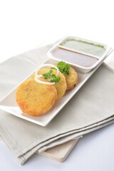 Indian deep fried round potato snack with green yogurt and red chilli sauce in white background vegan dim sum Halal menu