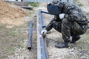Fototapeta premium Workers weld metal for sliding gates.