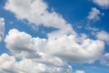 Naklejka na ściany i meble White clouds on a blue sky