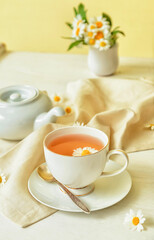 Obraz na płótnie Canvas Composition with cup of tea and flowers on table