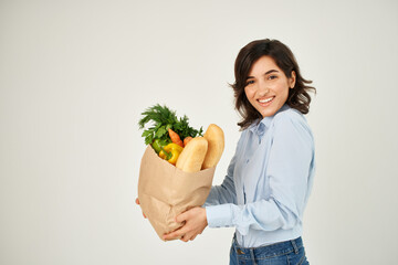 brunette in a blue shirt food bag vegetables healthy food