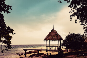 Nature in twilight period which including of sunrise over the sea and the nice beach. Summer beach with blue water and purple sky at the sunset.	