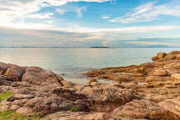 Nature in twilight period which including of sunrise over the sea and the nice beach. Summer beach with blue water and purple sky at the sunset.	