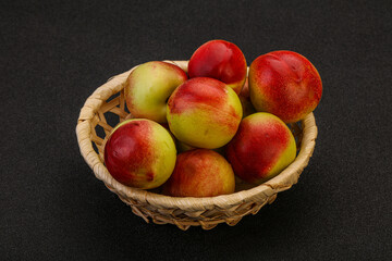 Sweet small nectarines in the basket