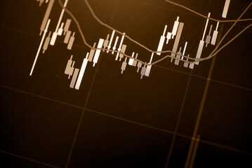 Abstract financial trading graphs and digital number of foreign exchange market trading on monitor. Background of gold and blue digital chart to represent stock market trend.