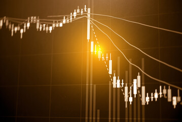 Abstract financial trading graphs and digital number of foreign exchange market trading on monitor. Background of gold and blue digital chart to represent stock market trend.