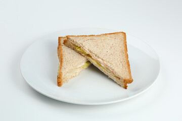 sandwich with ham and salad on wholegrain toasted bread in white plate. isolated club sandwich