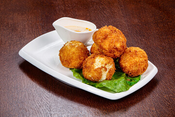 Fried cheese balls with sauce