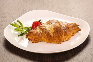 Sweet croissant in the plate