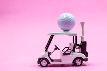 Golf cart with golf ball is on pink background
