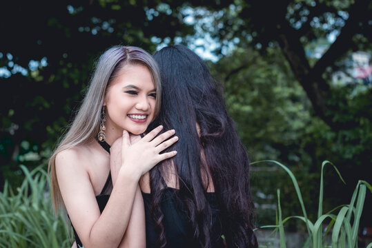 A Happy Asian Lady Hugs Her Bestfriend After A Heart To Heart Moment. Heartwarming Moment Between Besties.