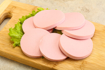 Sliced sausage snak over board