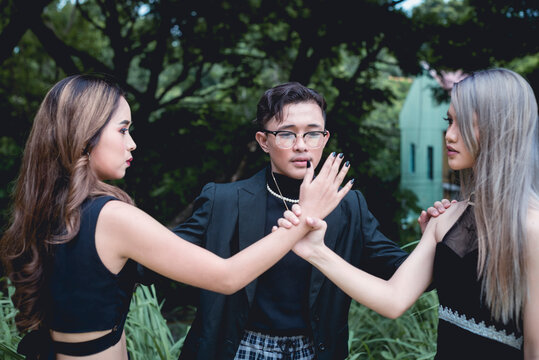 A Stressed Young Two-timing Man Tries To Breakup A Fight Between Two Women Fighting Over Him.