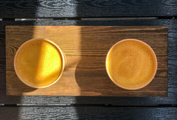 Orange coffee in glasses, top view.