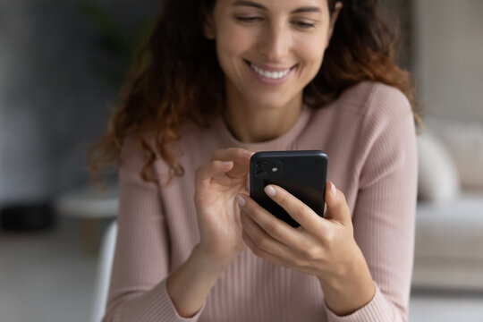 Crop Close Up Of Smiling Young Latino Woman Hold Cellphone Talk Speak On Video Webcam Call On Gadget. Happy Millennial Hispanic Female Use Smartphone Shopping Online. Communication Concept.