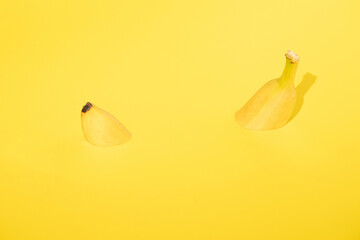 fresh yellow banana swims in yellow paper. tropical abstract art. minimalism with copy space