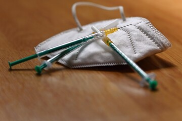 Syringe with needle and respirator. Concept for health and vaccination against covid 19 - sars cov...
