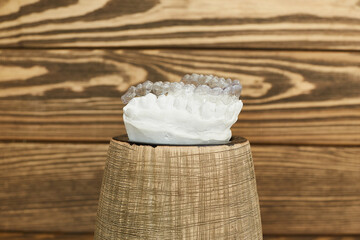 Orthodontic dental theme on a rustic background. Transparent invisible trays or braces for...