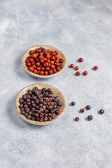 Fototapeta na wymiar Dried juniper berries in a small bowl.