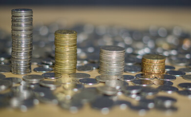 Closeup coins stack building. Many coins on foreground and background of the stack. Bokeh effect on background. Malaysia ringgit currency. 