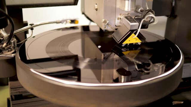 Recording tracks to the music vinyl disc form on a lathe machine, cutting music onto a lacquer