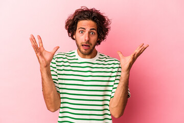 Young caucasian man isolated on pink bakcground screaming to the sky, looking up, frustrated.