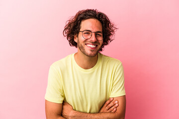 Fototapeta na wymiar Young caucasian man isolated on pink bakcground laughing and having fun.