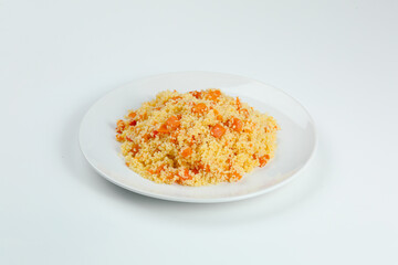 couscous with carrots in white plate closeup. couccous isolated on white background