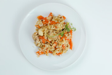 pilaf with chicken and carrot closeup in white plate. chicken pilaf on white background