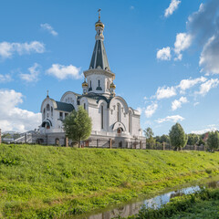 Temple of the Holy Blessed Grand Duke Alexander Nevsky on the bank of the Lithuanian stream against the backdrop of the dramatic sky in summer. Kaliningrad, Russia - 447067698