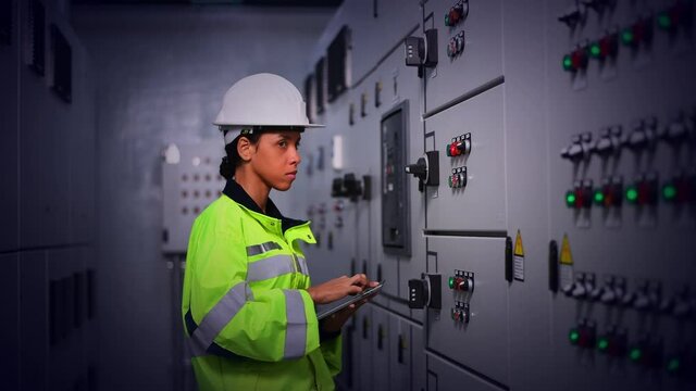 The engineer checking and inspecting at MDB panel .he working with electric switchboard to check range of voltage working in Main Distribution Boards factory.	