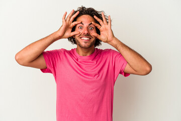 Young caucasian man isolated on white background keeping eyes opened to find a success opportunity.